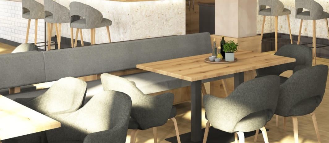 Elegantes Hochzeitslokal mit modernen, grauen Sitzecken und Holztisch, ideal für Traumhochzeiten in stilvollem Ambiente.