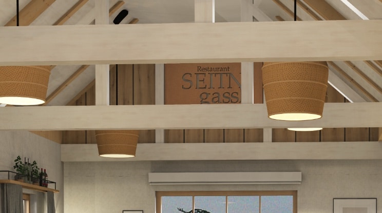 Gemütlicher Hochzeitslocation-Innenraum mit Holzbalkendecke und warmem Licht für eine romantische Feier.