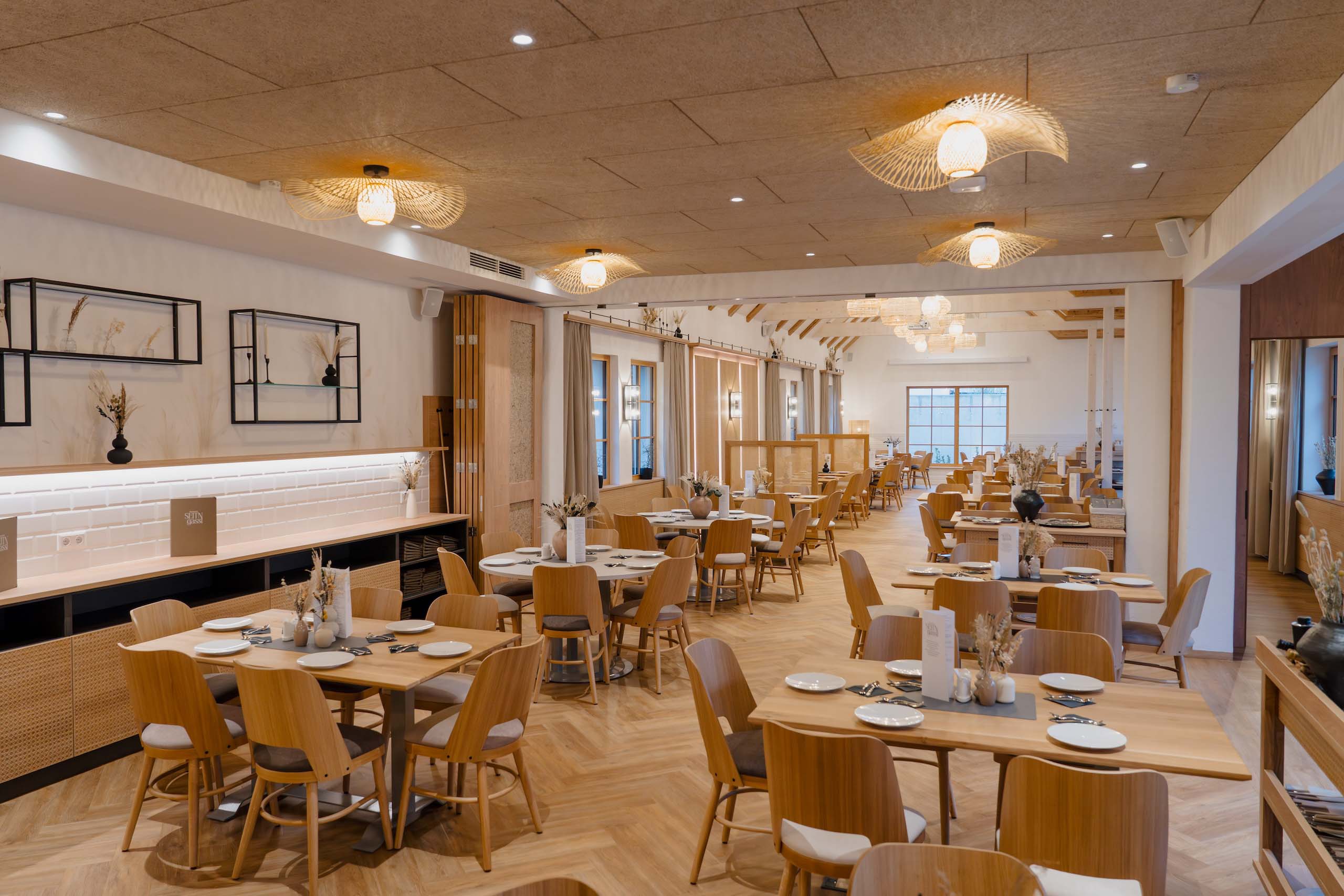 Elegante Hochzeitslocation mit stilvoll dekorierten Tischen und warmem Ambiente, perfekt für einen Hochzeitstraum.